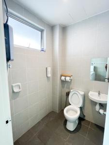 a bathroom with a toilet and a sink at Comfy Cafe 43 Homestay- Holiday Home in Tanah Rata