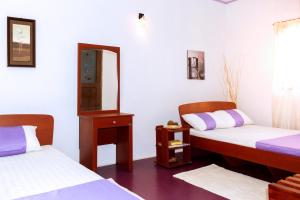 Postel nebo postele na pokoji v ubytování D'Villa Guest House