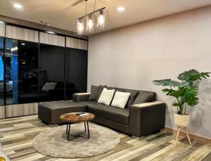 a living room with a couch and a table at State Tower Bangkok in Bangkok
