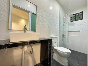 a bathroom with a toilet and a sink and a shower at Jk Home 12Pax 500Mbps 10Beds 4BathR 2Carparks in Kuching +37 photos