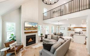 a living room with a couch and a fireplace at Farmhouse in the Burg in Gatlinburg