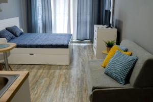 a living room with a bed and a couch at Art Studio Sea in Shkorpilovtsi