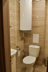 a small bathroom with a toilet and a sink at Art Studio Sea in Shkorpilovtsi +6 photos
