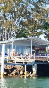 a house on a dock on the water at Edgewater Holiday Park in Port Macquarie