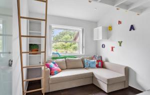 a living room with a couch and a book shelf at 3 Bedroom Amazing Home In Rødby in Rødby +17 photos