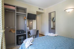 a bedroom with a blue bed and a desk at Grande Albergo in Sestri Levante