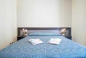 a bedroom with a bed with two towels on it at Grande Albergo in Sestri Levante