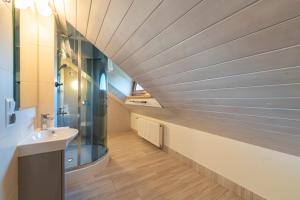 a bathroom with a sink and a glass wall at Apartamenty Ogrodowa w centrum Ustronia - Dream Apart in Ustroń +66 photos