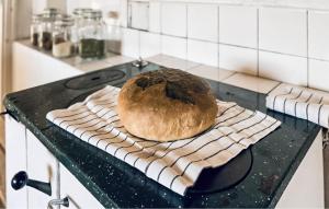 a loaf of bread sitting on top of a stove at 2 Bedroom Gorgeous Home In Hallaryd in Hallaryd