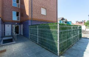a fence in front of a brick building at Gorgeous Home In Miengo With Wifi in Miengo