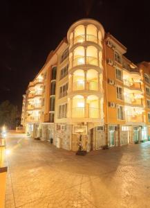 a large apartment building at night with a street at CunninghamsSilver in Sunny Beach