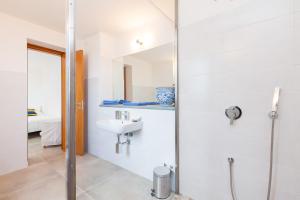 a white bathroom with a sink and a shower at SAN LEO, Castellabate - Mafalda in Castellabate +20 photos