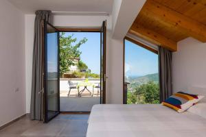 a bedroom with a bed and a view of a patio at SAN LEO, Castellabate - Mafalda in Castellabate