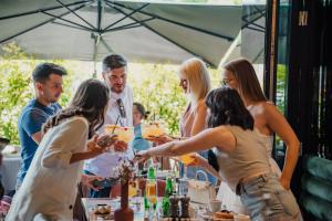 a group of people standing around a table with drinks at Mercure Timisoara in Timişoara