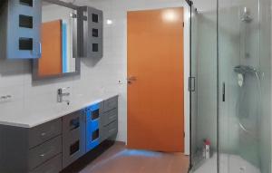 an orange door in a bathroom with a shower at 3 Bedroom Gorgeous Apartment In Borhaug in Borhaug