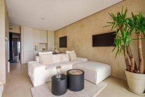 a living room with a white couch and a table at Boho z Widokiem na Morze by Perłowa Przystań Rent in Sianozety