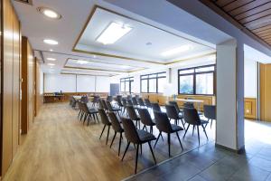 a room with rows of chairs in a classroom at Naturhotel Blaubach in Blaubach