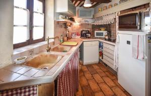 a kitchen with a sink and a refrigerator at 2 Bedroom Stunning Home In Vedène in Vedène