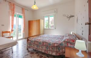 a bedroom with a bed in a room with windows at Beautiful Apartment In Castellabate in Castellabate