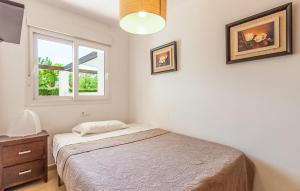 a bedroom with a bed and two pictures on the wall at Nice Apartment In Alhama De Murcia in Alhama de Murcia