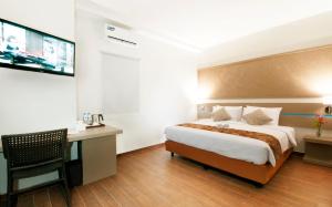 Krevet ili kreveti u jedinici u okviru objekta Genio Hotel Manado