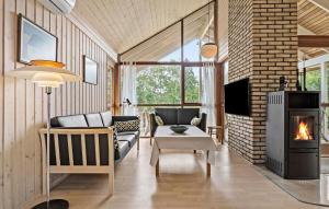 a living room with a couch and a fireplace at 3 Bedroom Beautiful Home In Løgstør in Løgstør