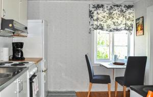 a kitchen with a table and chairs and a window at 2 Bedroom Awesome Home In Kristinehamn in Edet
