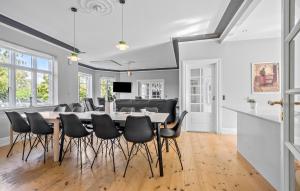 a dining room with a table and chairs at 5 Bedroom Nice Home In Nyborg in Nyborg