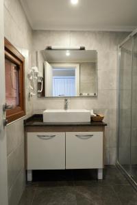 a bathroom with a sink and a mirror at Phellos Suites Boutique Hotel in Şile +37 photos
