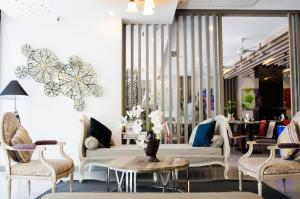 a lobby with a couch and chairs and a table at Mirage Express Patong Phuket Hotel in Patong Beach