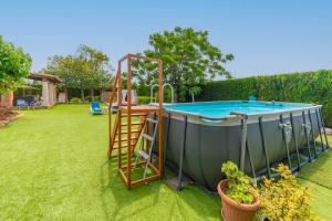 a hot tub with a ladder next to a pool at Ses Canyes in Muro