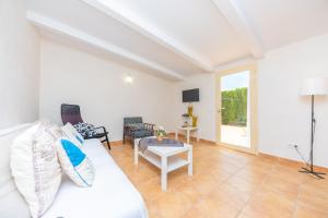 a living room with a white couch and a table at Ses Canyes in Muro