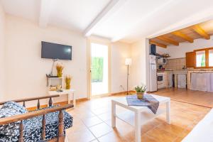 a living room with a couch and a table at Ses Canyes in Muro