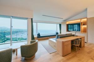 a living room with a view of the ocean at samana hotel Yakushima in Yakushima