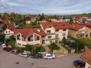 a large house with cars parked in a parking lot at Apartamenty Ogrodowa w centrum Ustronia - Dream Apart in Ustroń