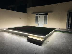 a room with a large bed with a bench in it at توتn in Hail