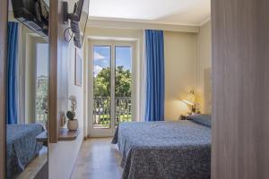a hotel room with two beds and a window at Grande Albergo in Sestri Levante