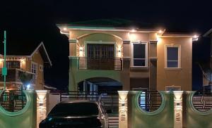 a car parked in front of a house at night at The Royal Haven Herstelling GY in Nismes