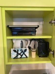 a yellow shelf with dishes and other items on it at JOY Studio in Ravda +15 photos