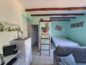 a small room with a bed and a ladder at SPITIKARIOTIKO Pergola Home in Raches