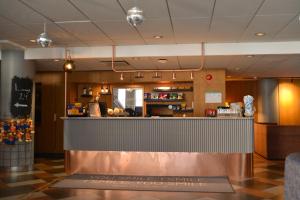a bar in a restaurant with a counter at Quality Hotel The Mill in Malm&ouml;