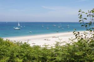 a beach with boats in the water and people on it at Hypercentral flat for 6 in Lorient in Lorient +10 photos
