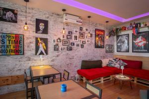a living room with a red couch and a brick wall at Grande Albergo in Sestri Levante