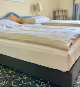 a close up of a bed in a bedroom at Country Hotel Timmendorfer Strand in Timmendorfer Strand