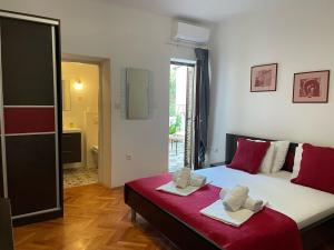 a bedroom with a bed with two towels on it at Apartments Vila Miranda 2 in Barbat na Rabu