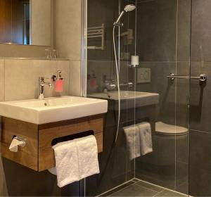 a bathroom with a sink and a shower at Country Hotel Timmendorfer Strand in Timmendorfer Strand