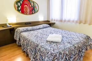 a hotel room with a bed with a pillow on it at Melas Hotel in Merate