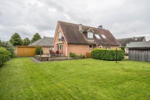 a house with a large yard with a grass yard at Ferienwohnung Lichtblick in Grömitz
