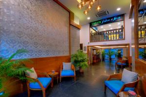a lobby of a restaurant with blue chairs at TreeHouse Neptune in Panaji
