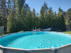 a large pool of water with two chairs in it at садиба доличі in Bovkun